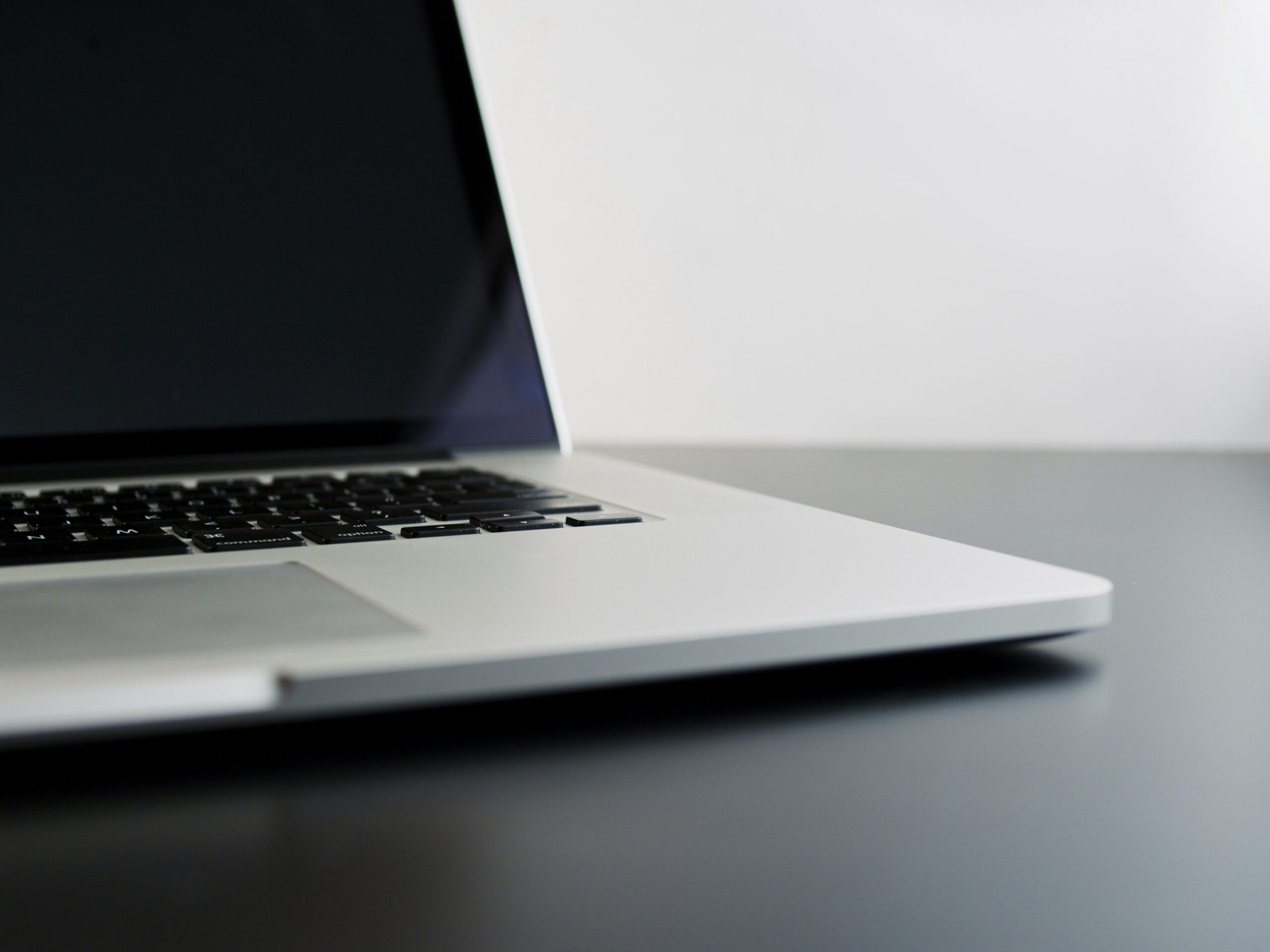 8-Considerations-Before-Buying-Used-Technology-scaled.jpg silver laptop computer on black table