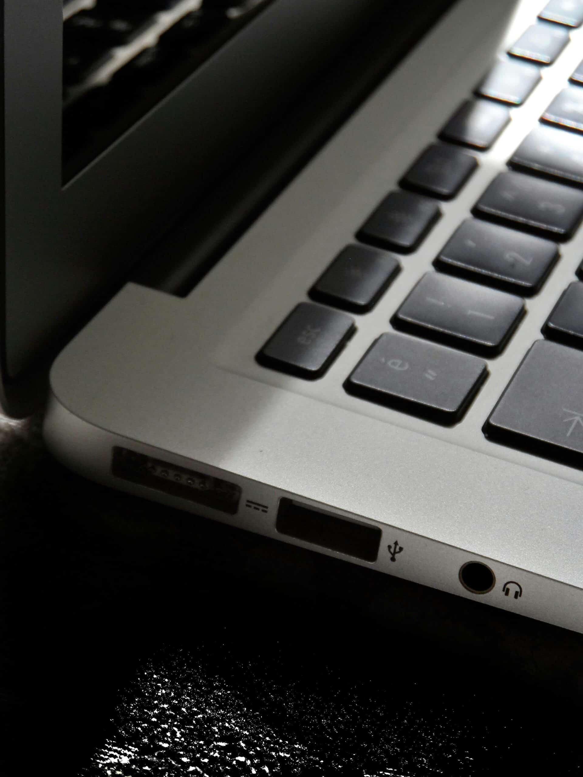 The-Zombie-SaaS-Audit_-Finding-the-3-Apps-Your-Former-Employees-Still-Access-scaled.jpg Free Detailed view of a silver laptop showing keyboard and multiple ports. Stock Photo